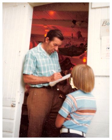 196x - Renting out oars for boats, and running the PA. Nice combination of plaids.jpg